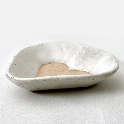 Speckled ceramic dish on a white background