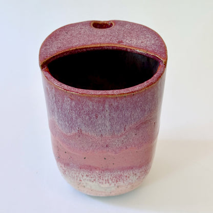 Handmade stoneware to-go mug featuring layered tonal pink glaze from deep berry to soft blush over speckled clay.