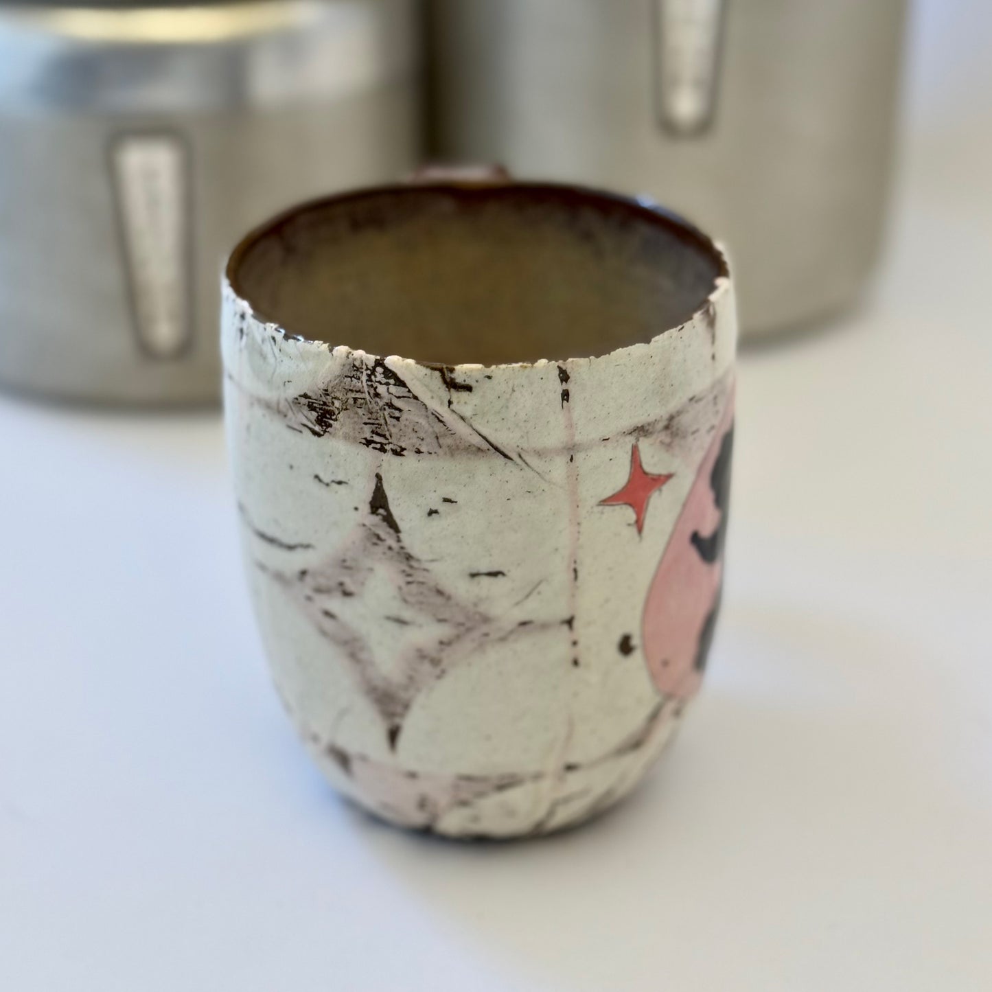 Pink-and-white ceramic mug featuring a black retro poodle silhouette against a pink circle.