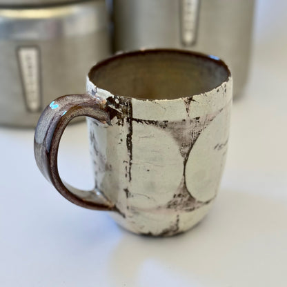 Pink-and-white ceramic mug featuring a black retro poodle silhouette against a pink circle.