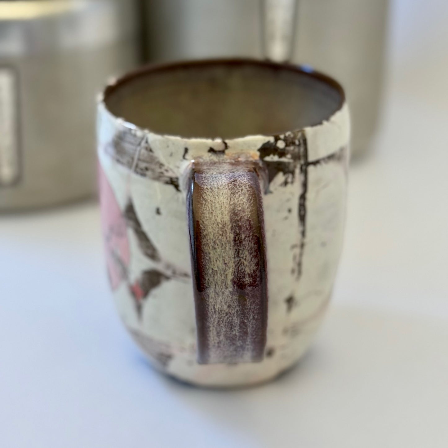 Pink-and-white ceramic mug featuring a black retro poodle silhouette against a pink circle.