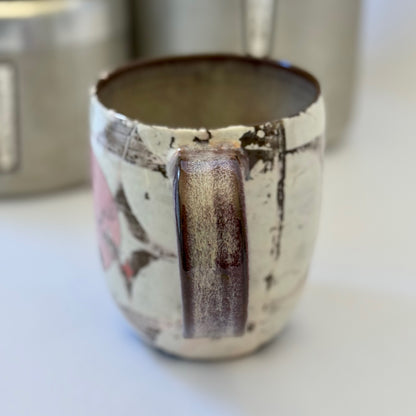 Pink-and-white ceramic mug featuring a black retro poodle silhouette against a pink circle.