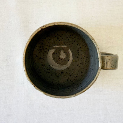 Ceramic mug with mid century design on a white surface
