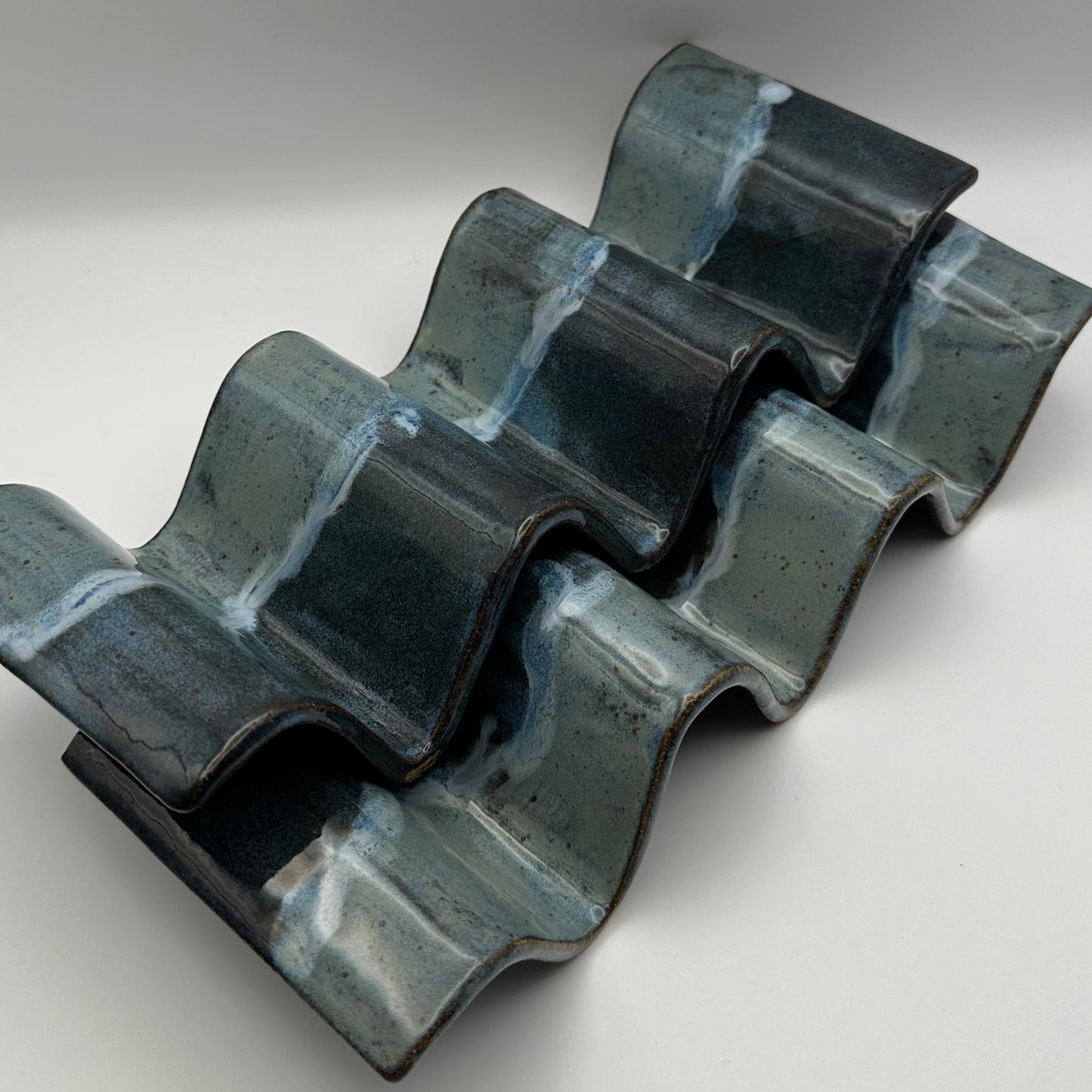 Blue ceramic taco holders on a light background