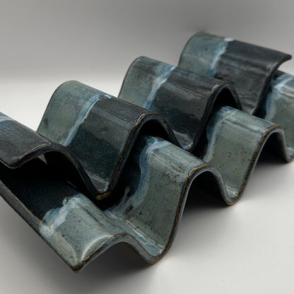 blue ceramic taco holders on a light background