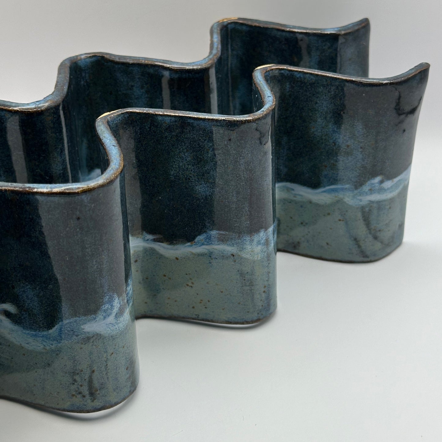 blue ceramic taco holders on a light background