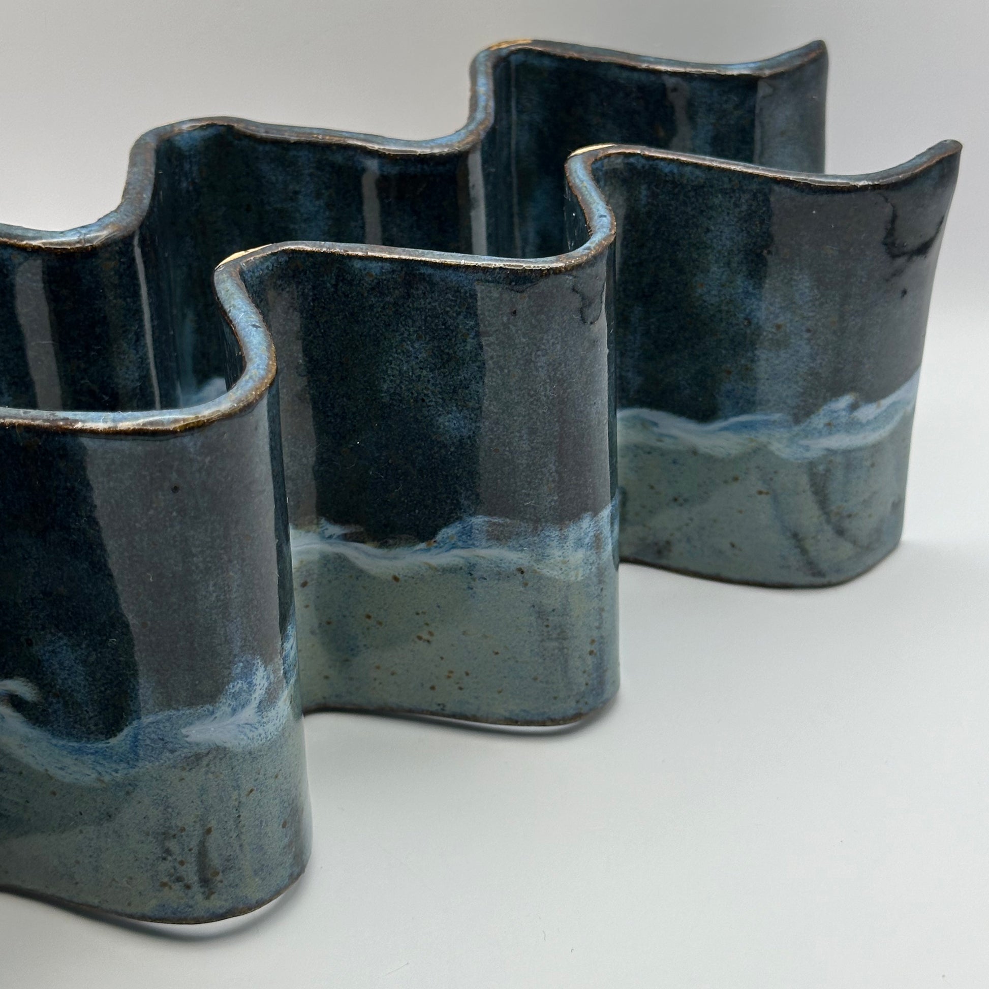 blue ceramic taco holders on a light background
