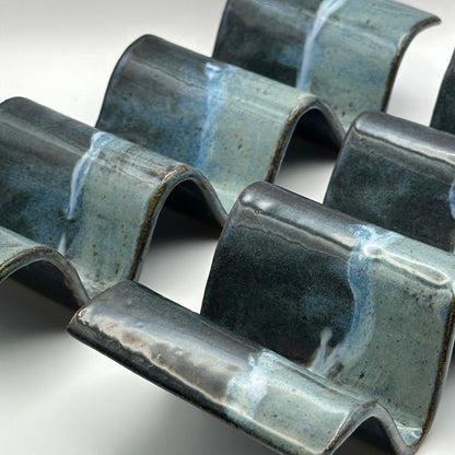 blue ceramic taco holders on a light background