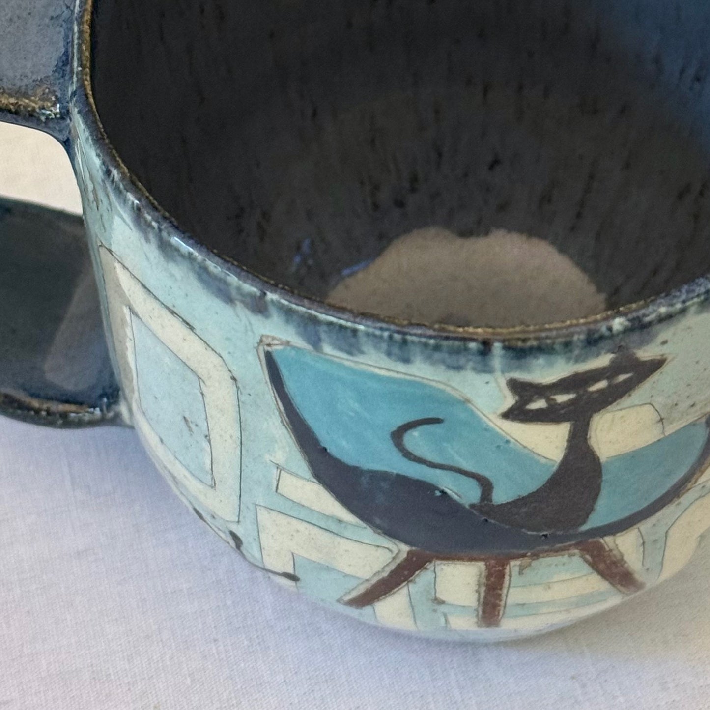 Handmade mug with black cat sitting in mid-century chair and atomic shapes