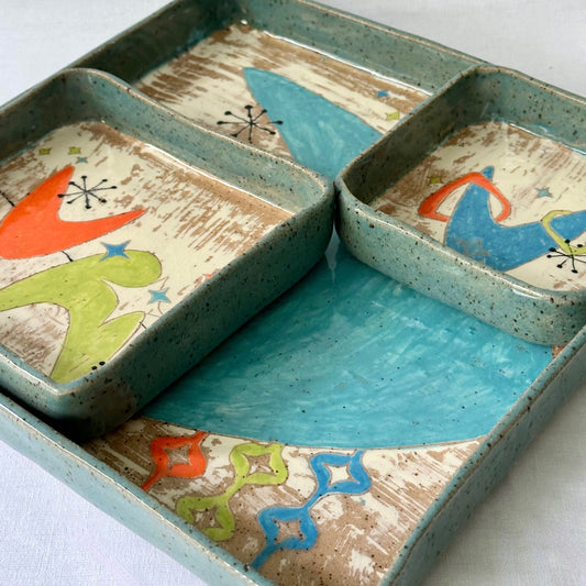 Decorative ceramic charcuterie set with mid century designs on a white background