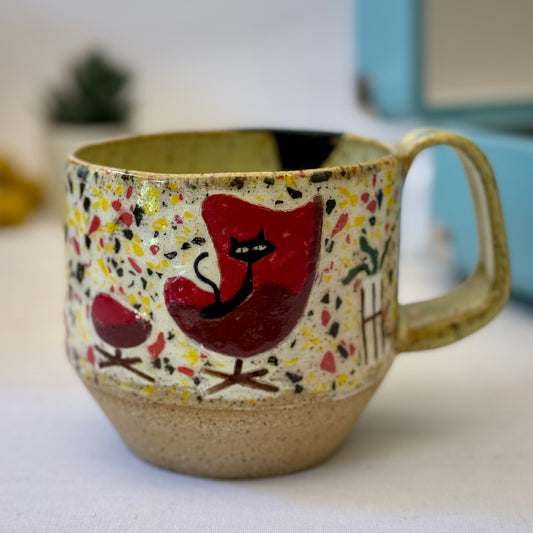 Handmade mug with black cat in red chair and terrazzo pattern