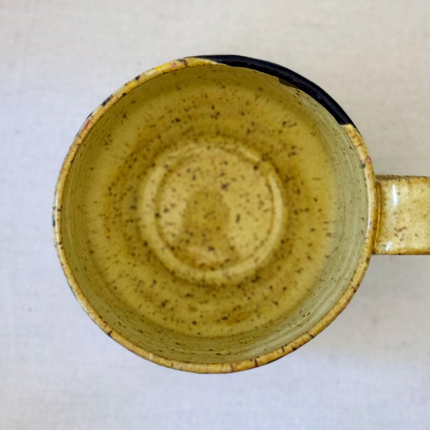 Handmade mug with black cat in red chair and terrazzo pattern