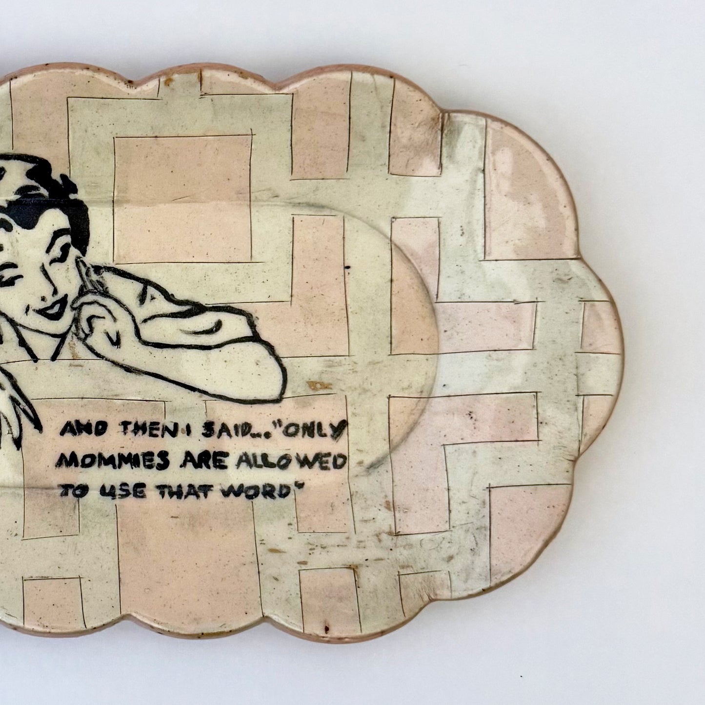 Decorative plate with a vintage-style illustration of a woman and text on a white background