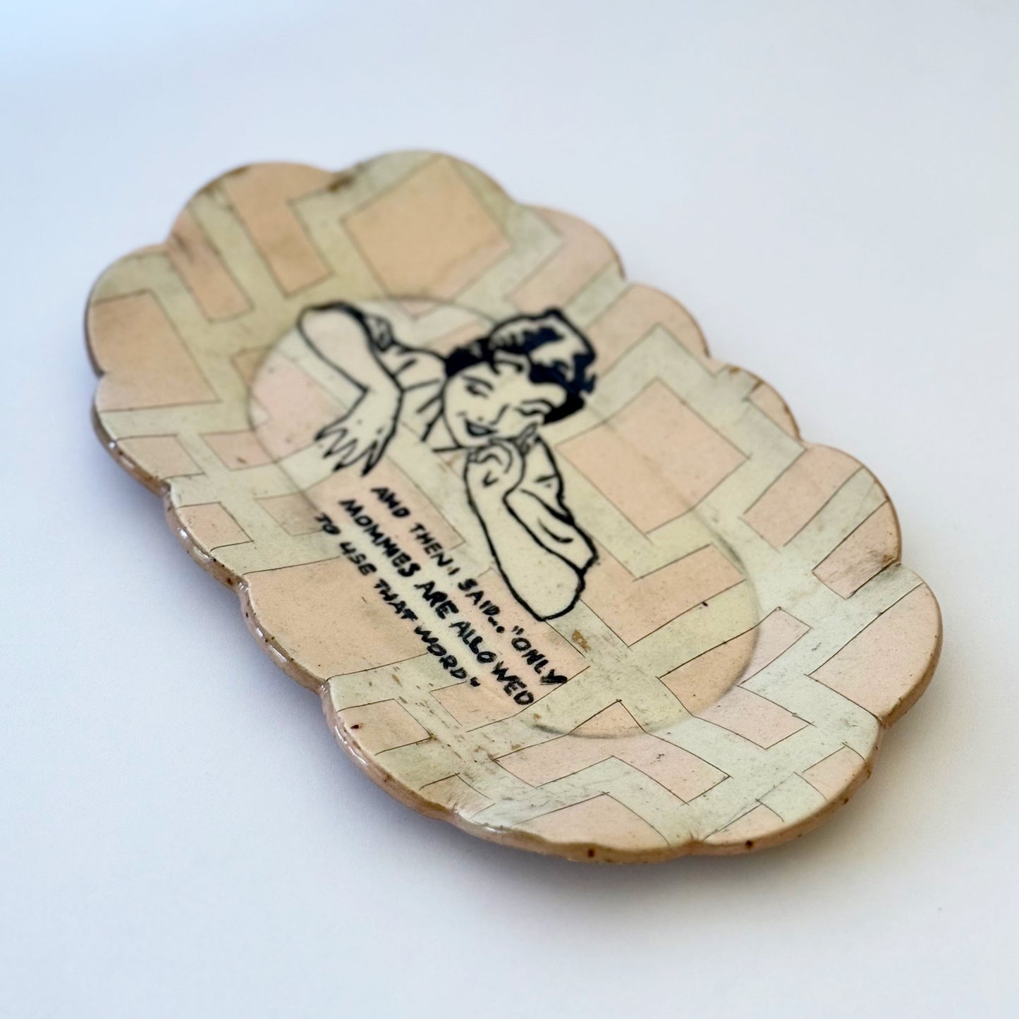 Decorative plate with a vintage-style illustration of a woman and text on a white background