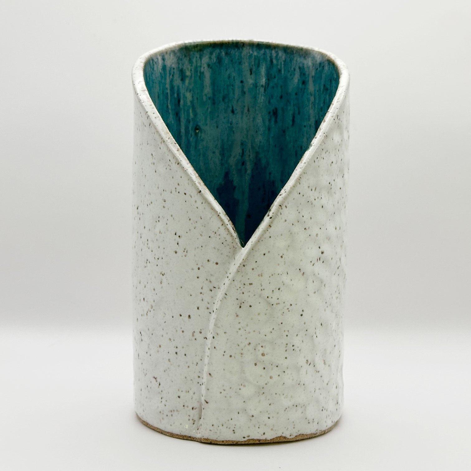 white and turquoise ceramic wine chiller