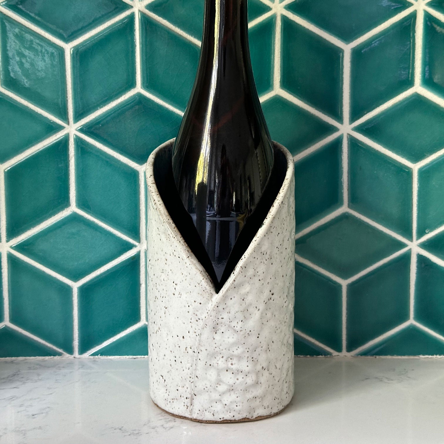 white and turquoise ceramic wine chiller