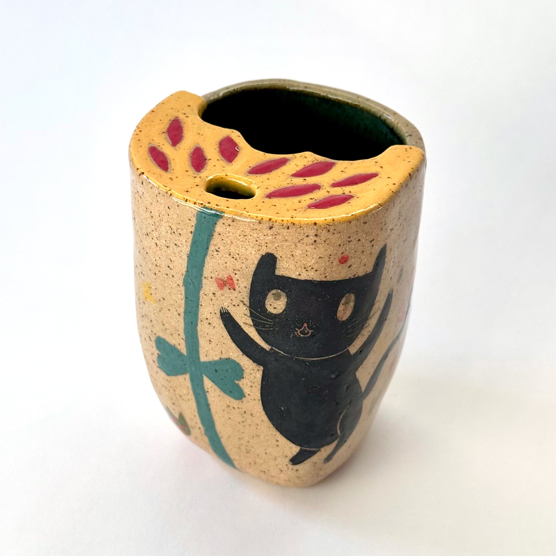 Ceramic to go mug with a black cat design on a white background