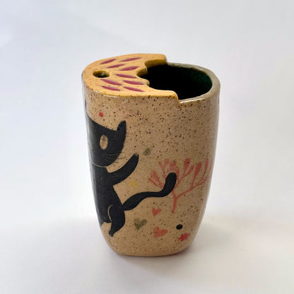 Ceramic to go mug with a black cat design on a white background